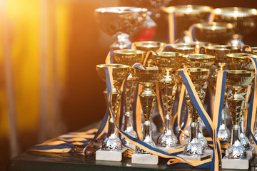 Golden goblets in sunlight with blurry background