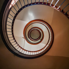 Old renovated wooden high spiral staircase