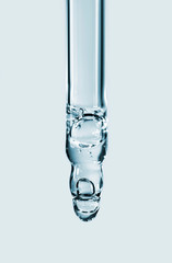 Cosmetic pipette with hyaluronic acid. Transparent gel with bubbles close-up. Gel cream or serum. A sample of a cosmetic product. Antibacterial gel.
