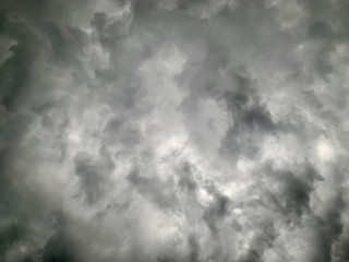 Black clouds formed before the rain, used for make a background image. Clouds become dark gray like a big smoke before rainfall. Thunderstorm is a storm with lightning and thunder.