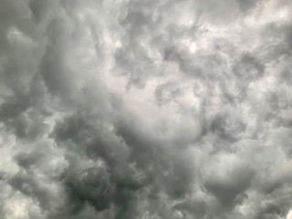 Black clouds formed before the rain, used for make a background image. Clouds become dark gray like a big smoke before rainfall. Thunderstorm is a storm with lightning and thunder.