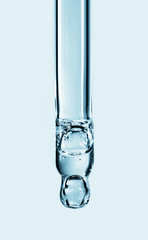 Cosmetic pipette with hyaluronic acid. Transparent gel with bubbles close-up. Gel cream or serum. A sample of a cosmetic product. Antibacterial gel.