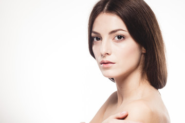 Obraz premium Young beautiful woman with hands portrait with healthy skin studio on white