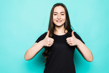 Portrait of gorgeous girl showing thumbup isolated over turquoise background