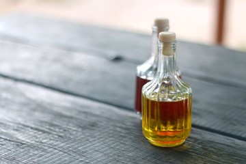 Bottles of olive oil and vinegar on a table. Selective focus.