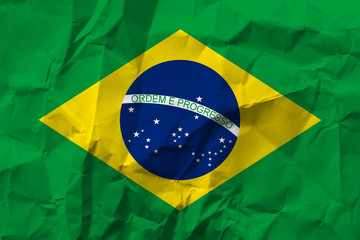 Brazil national flag on crumpled paper.