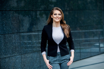Fototapeta na wymiar Confident business expert. Happy successful professional posing near office building. European girl. Russian business lady. Female business leader concept. Portrait Of Successful Business Woman