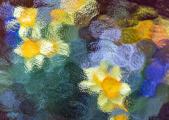 Abstract flower arrangement of a bunch of flowers behind a frosted glass window.
