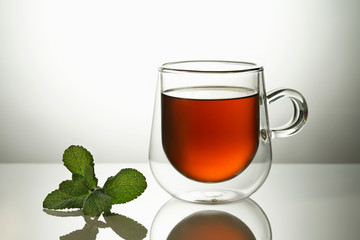 Glass transparent mug with tea