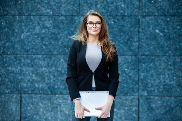 Confident business expert. Happy successful professional posing near office building. European girl. Russian business lady. Female business leader concept. Portrait Of Successful Business Woman