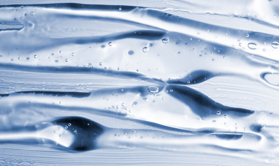 Transparent gel with bubbles close-up. Smear of face gel cream. The texture of gel cream. A sample...