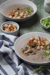 Creme soup with mushrooms in white bowl