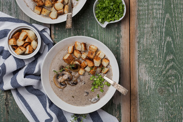 Creme soup with mushrooms in white bowl