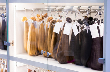 Exhibition of multicolored hair extensions in beauty salon