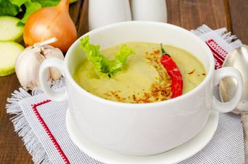 Spicy vegetarian vegetable puree soup green color, healthy eating.