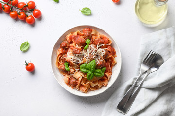 Pasta fettuccine with meatballs, parmesan, cherry tomatoes, basil. View from above.