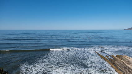 surfer in the sea and waves at San Luis Obispo, California