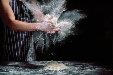 Obraz na płótnie Canvas Chef clap white flour dust man hand on dark background