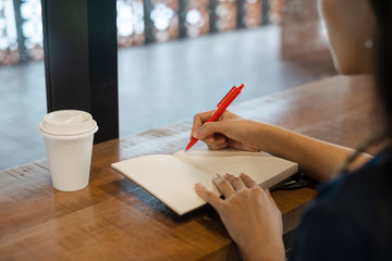 Writing on notebook.