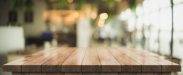 Empty old wood table top with bokeh coffee shop interior background