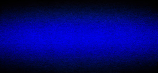 Good quality porous grunge dark blue color cardboard paper texture close-up with vignette dimming on the sides.