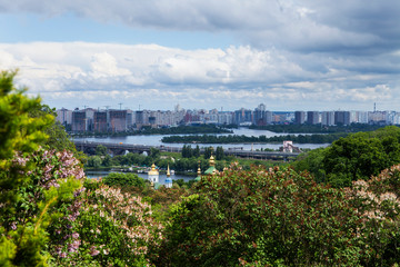 Cityscape of Kyiv with lilac blossom in spring.