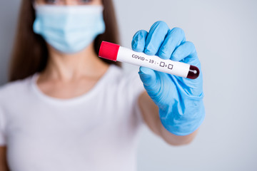 Cropped closeup blurred photo of lady patient hospital examination hold arm analysis giving doctor blood probe covid test waiting results wear face mask isolated grey color background
