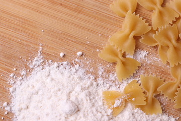 Italian Farfalle Pasta on the light beige rustic background