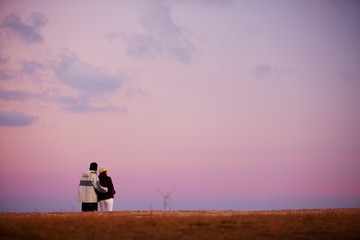 silhouette of a couple walking on the mountain
