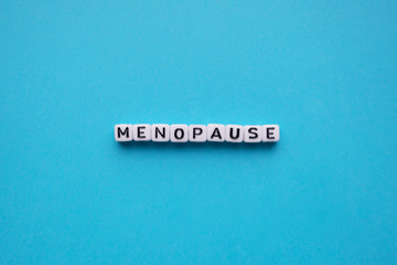 Menopause word cubes on a blue background