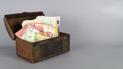 Money chest with lots of banknotes and copy space