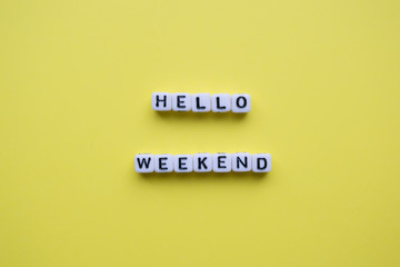 Hello weekend words on yellow background.