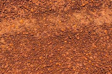 The background of small brown grit on a dirt road