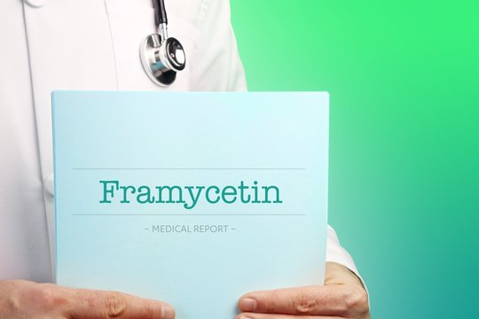 Framycetin. Doctor holds documents in his hands. Text is on the paper/medical report. Green background.
