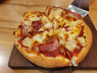 Pizza on a wooden mat