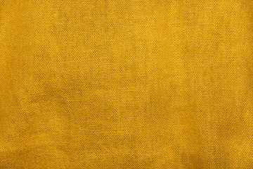 Crumpled yellow fabric texture as background