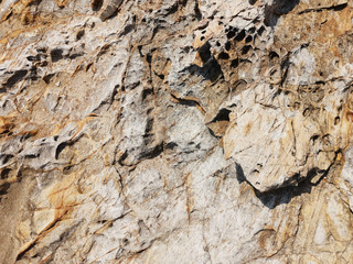 Background design texture of natural stone granite. multi-colored - red, gray.