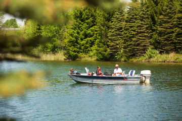 Grandpa fishing with his grandchildren on boat