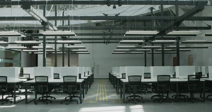 Interior of empty big workspace with covered computers