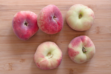 Donut peaches on a wooden board