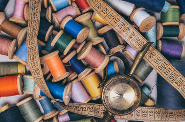 
spools of colored threads 
with a meter and time