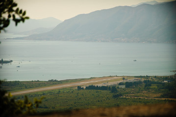 The view of the airport and the Bay with mountains at sunset