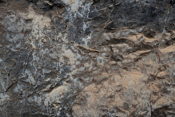 the texture of the cave or rocky cliffs are rugged with vignette background