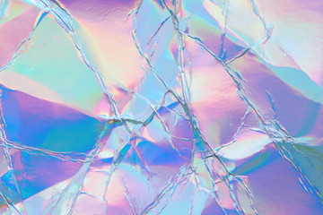 Blurred abstract Modern pastel colored holographic background in 80s style. Crumpled iridescent...