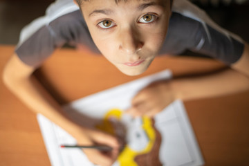 Boy, drawing at home, doing his homework