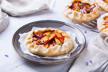 Homemade seasonal summer fruit galette, tart, pie with nectarines, peaches