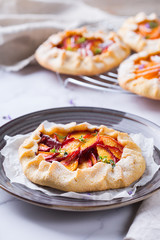 Homemade seasonal summer fruit galette, tart, pie with nectarines, peaches
