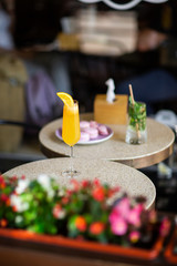 Glass with classic mojito cocktail with lemon and mint, cold refreshing drink or beverage with dessert on bright background. Overhead view, copy space. Advertising for cafe menu.