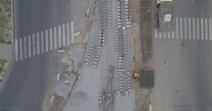 Work activity on the construction of a road. Crushed stone on substrate with rails. Support activities and reconstruction of tram tracks. Aerial view from drone