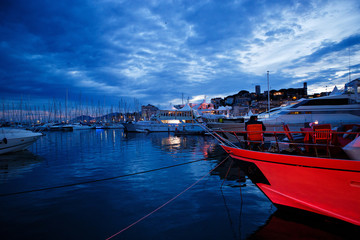 Fototapeta premium luxurious yachts and boats in the port at night. evening, pier, sea, and sky. 